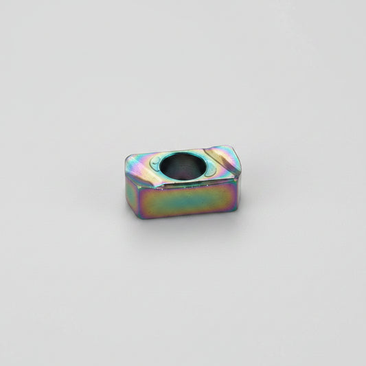 LNMU 0303 coated carbide milling insert with a rectangular design, central mounting hole, and rainbow PVD coating on a white background.