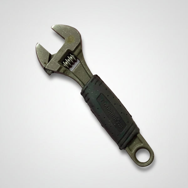 Taparia Adjustable Spanner 1170S-6 inch with ergonomic black rubber grip handle and precision adjustable jaw, placed on a pink background. Ideal for tightening and loosening nuts and bolts in plumbing, automotive, electrical, and maintenance applications.